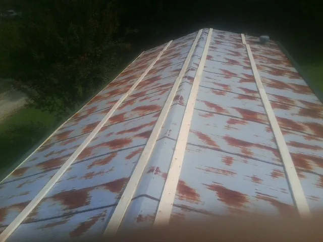 Rusted metal roof panels with new wood purlins before replacement — Storm Damage Roof Repair in Frostburg by Roofing Brothers
